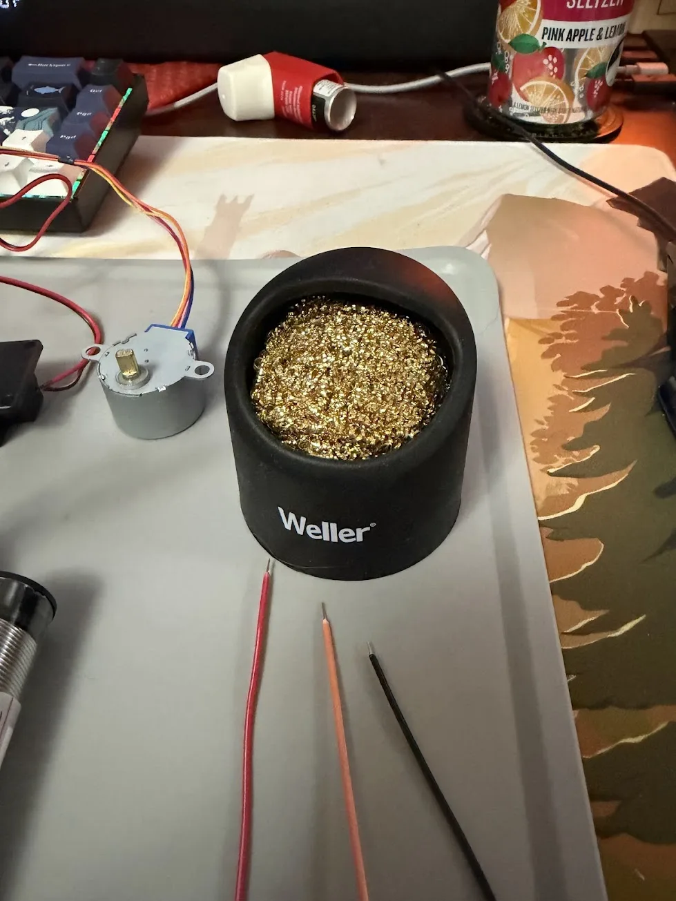 Weller brass sponge tip cleaner on the workmat, used for wiping and tinning the soldering iron tip